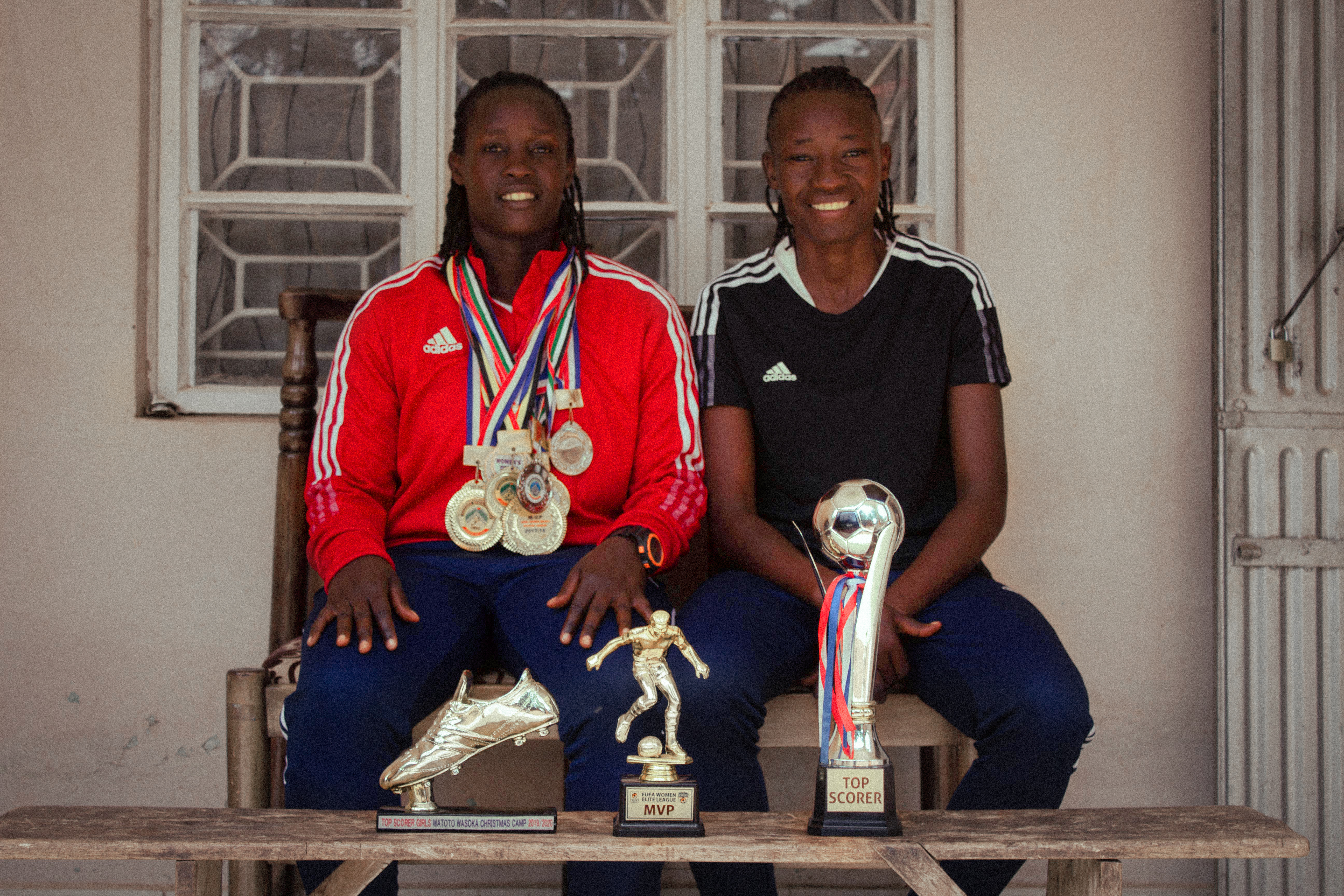 women holding trophies