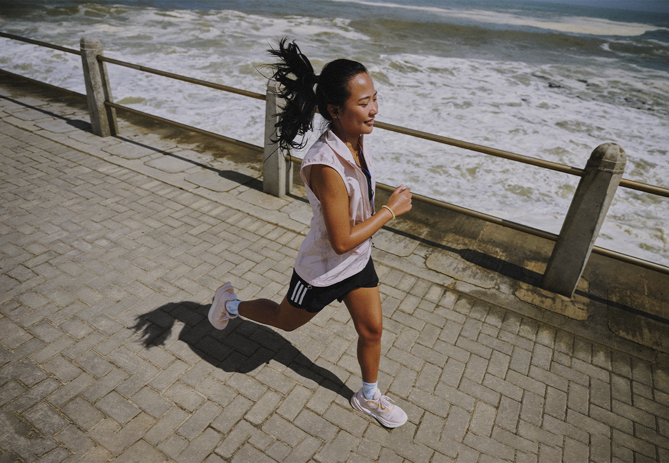 Image of a woman running outdoors wearing Supernovas.