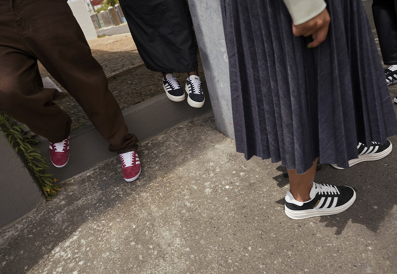 Close-up image of people standing outdoors wearing adidas Gazelles.