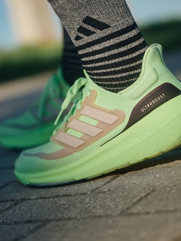 adidas-ultraboost-running-shoe-green-grey-black-socks-close-up-image