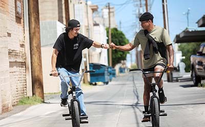 Professional BMX rider DeMarcus Paul and a member of his community reaching their summit