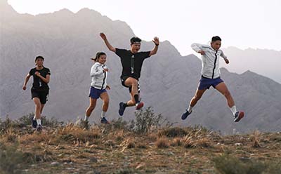 Professional trail runners reaching their summit