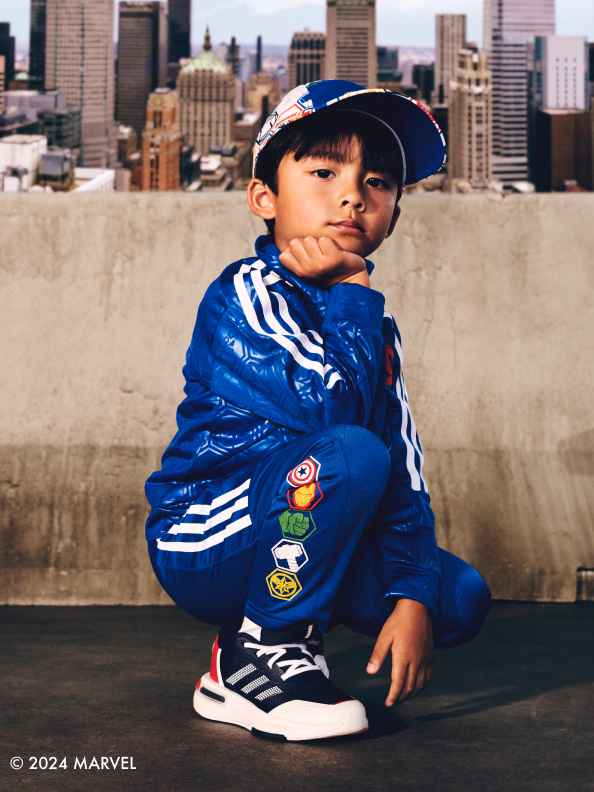 Child crouching wearing the adidas | Avengers collection