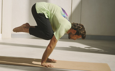 Man doing yoga while wearing adidas products