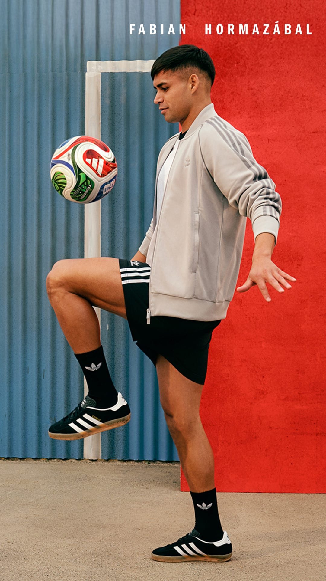 A young man in athletic attire is balancing a soccer ball on his foot in front of a red background with his name displayed.