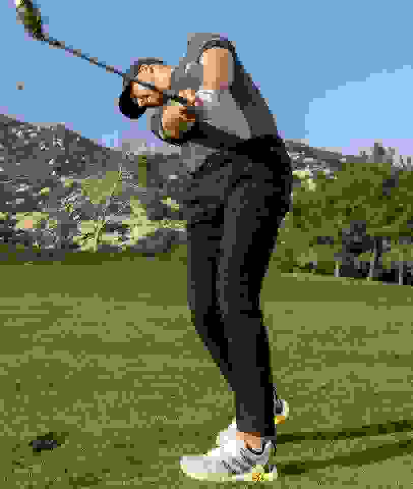 Daniel Berger swings a golf club in CODECHAOS golf shoes.
