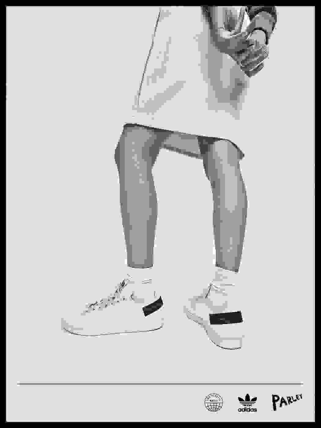 Lower half of model wearing Stan Smiths on a white background.