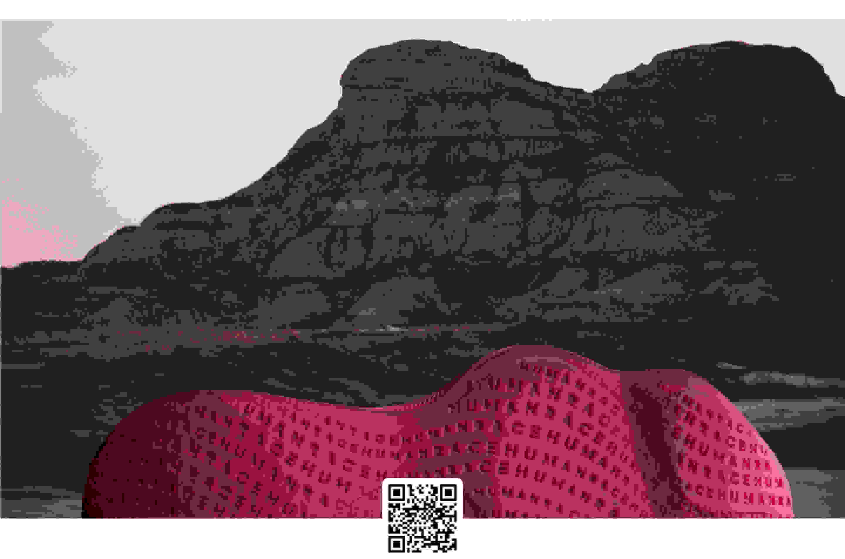 The outsole of a burgundy Humanrace Sičhona shoe against the backdrop of a mountain and tinted sky.