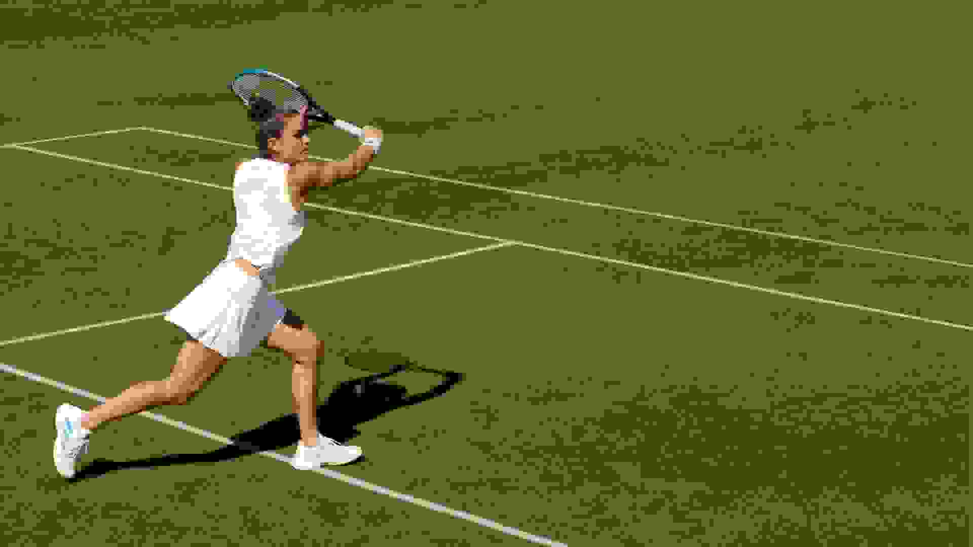 Sakkari playing tennis on a green court