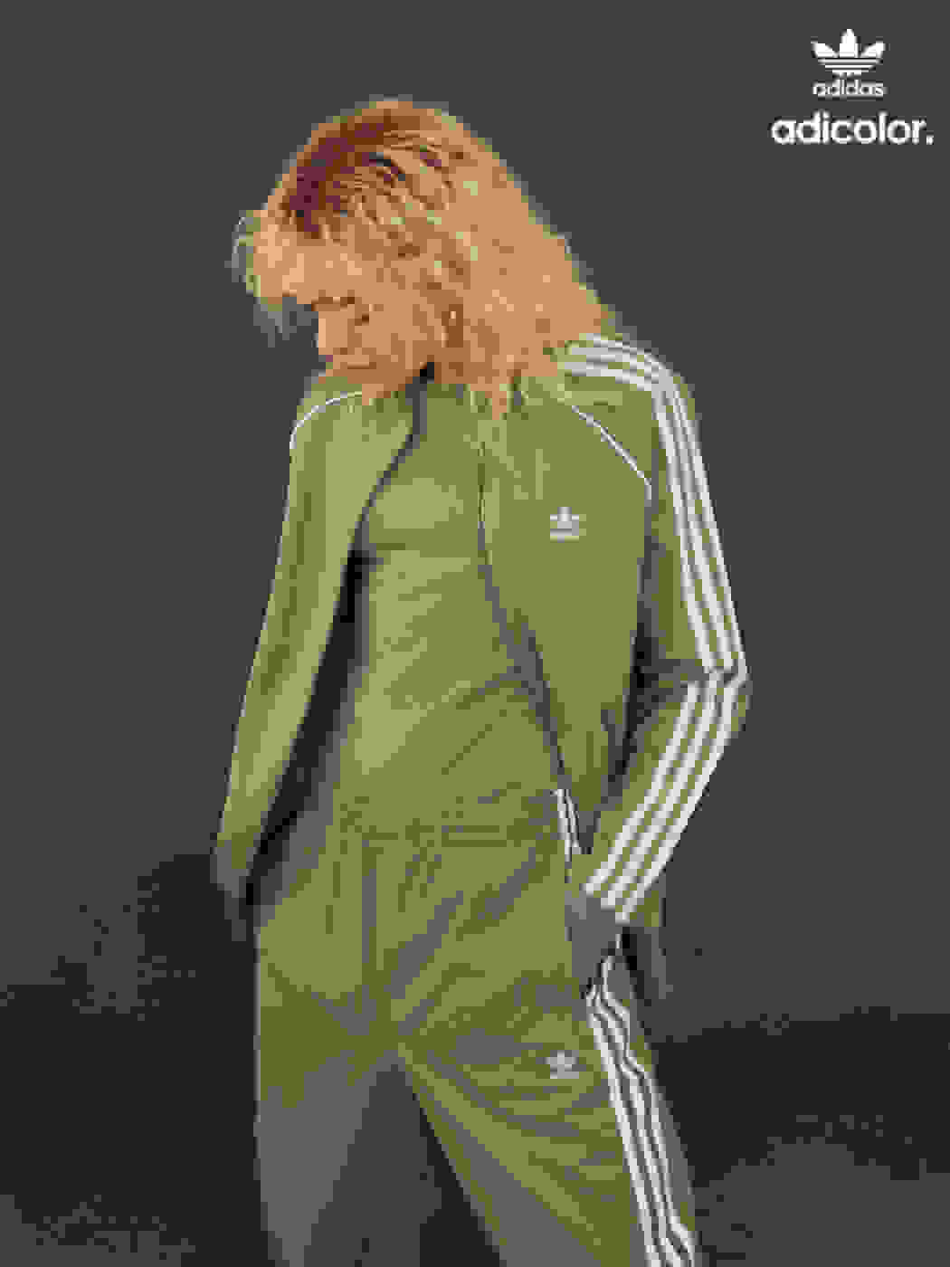 Woman wearing a stylish contemporary neutral colored tracksuit.