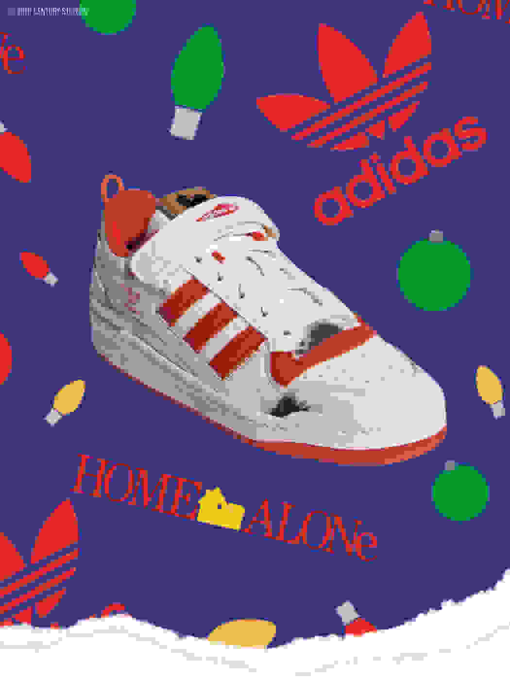A close-up of the shoe with a white upper, printed burn marks and red logos, Three Stripes, lining and outsole on festive wrapping paper.
