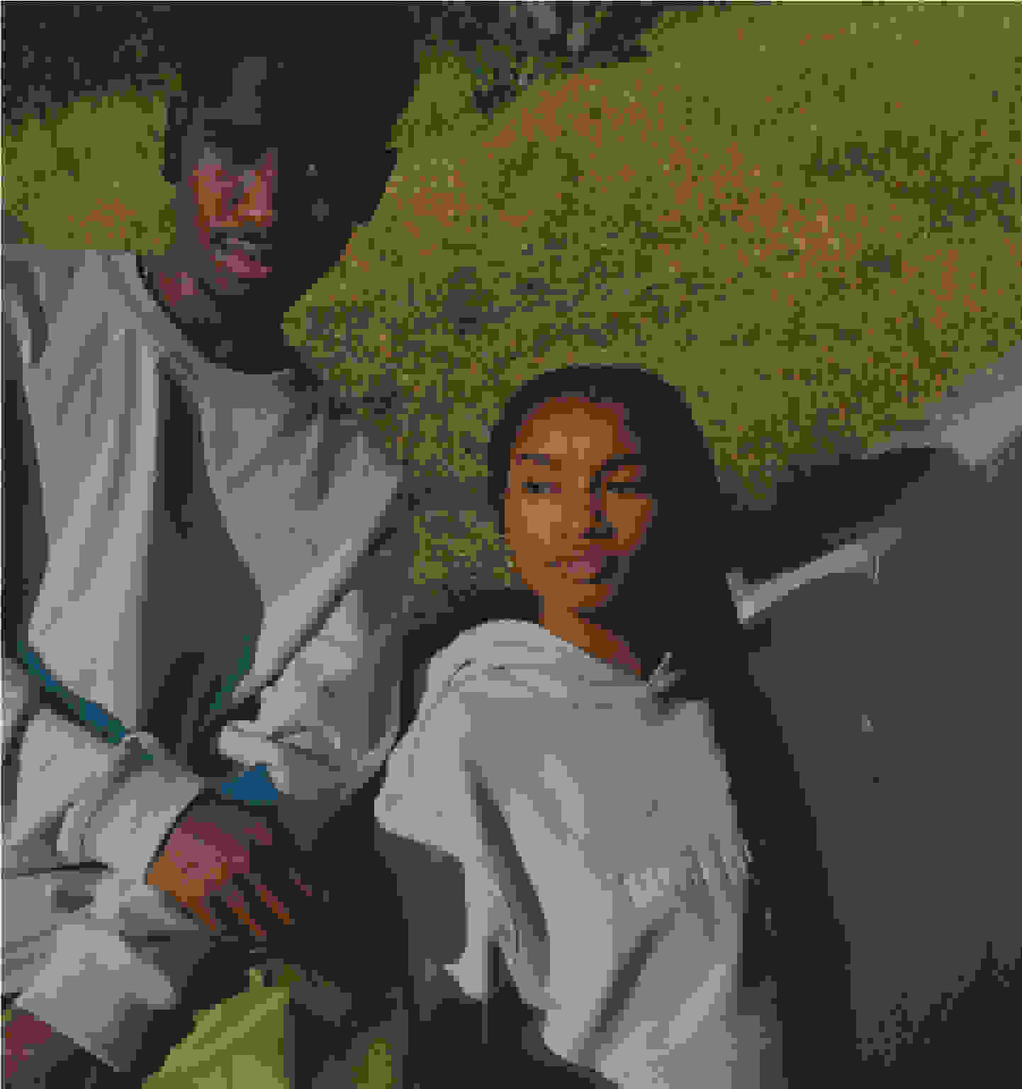 Two models wearing light blue Humanrace sweater and gray hoodie lean against wall