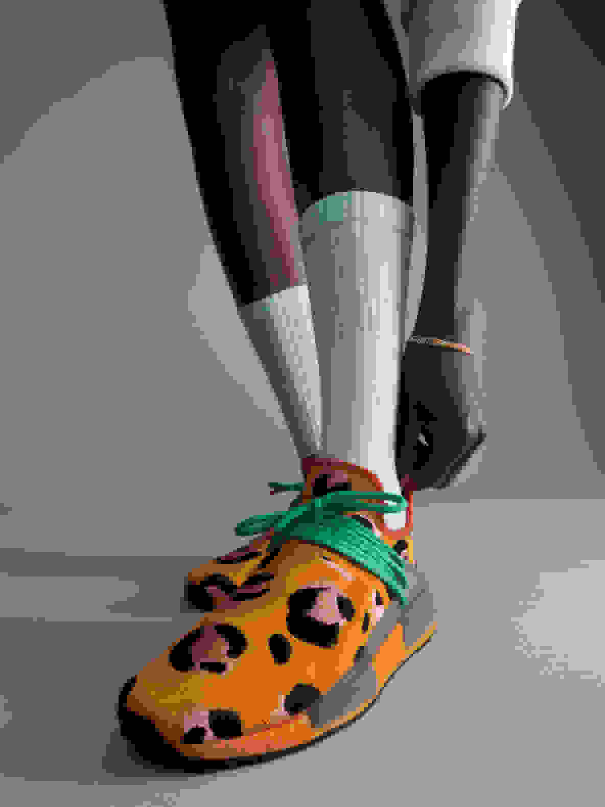 Close-up of side details on orange Hu NMD Animal Print shoe
