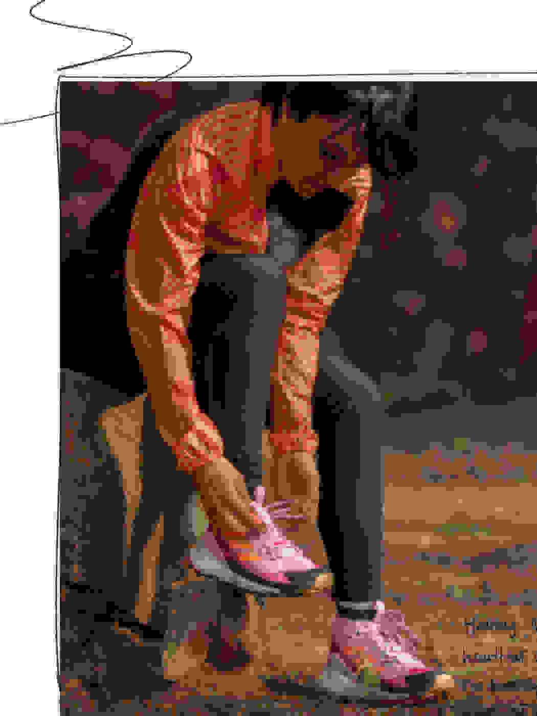 One person tieing their shoelaces while sitting on a rock, wearing the Breast Cancer Awareness Collection running jacket and leggings.