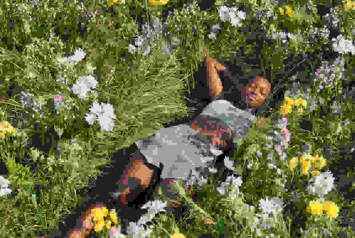 Woman lying in a flower field