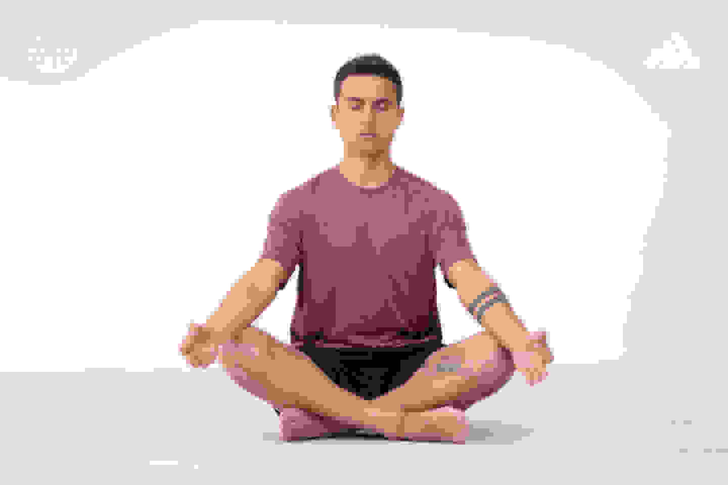 Football player Paulo Dybala is seated in a yoga pose, wearing an outfit from th Make Space Yoga collection.