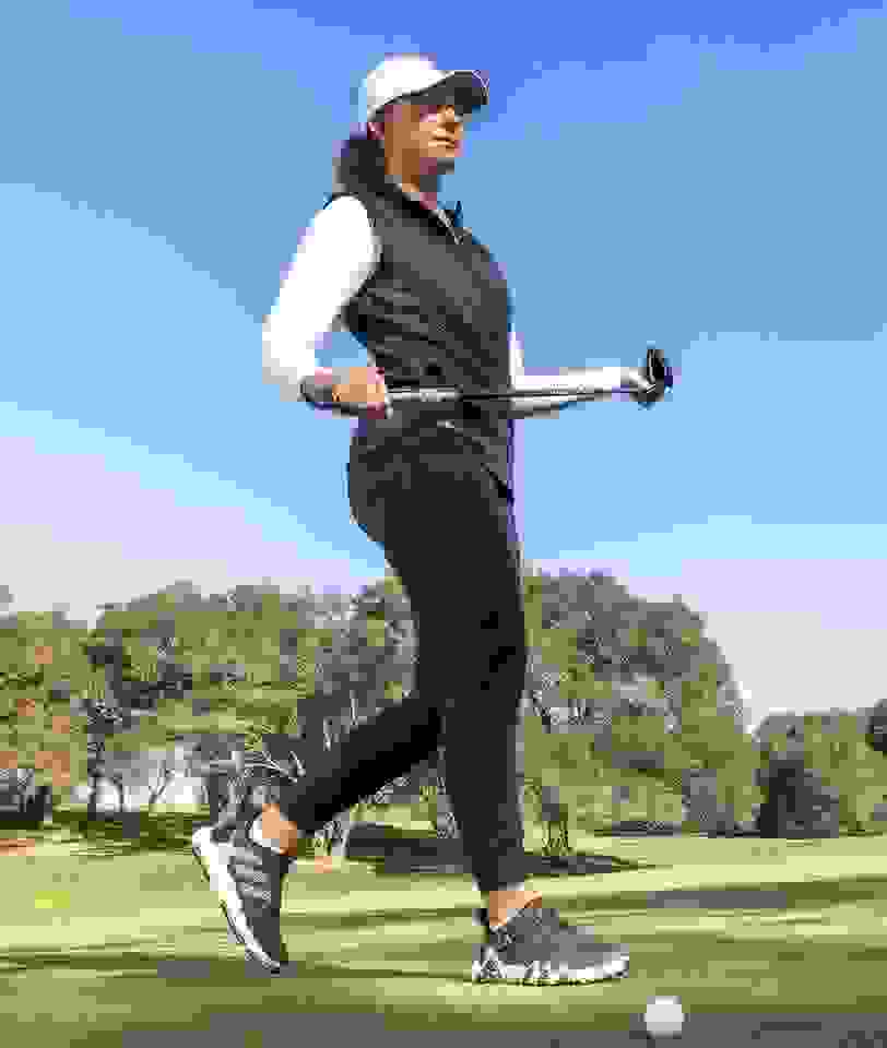 Linnea Strom walks with a golf club in CODECHAOS.