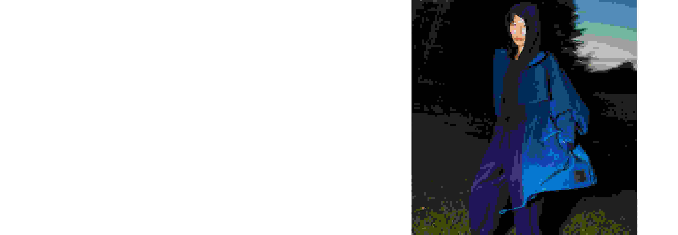 A model standing on grass at dusk, wearing blue garments and white sneakers from the Y-3 SS21 collection.