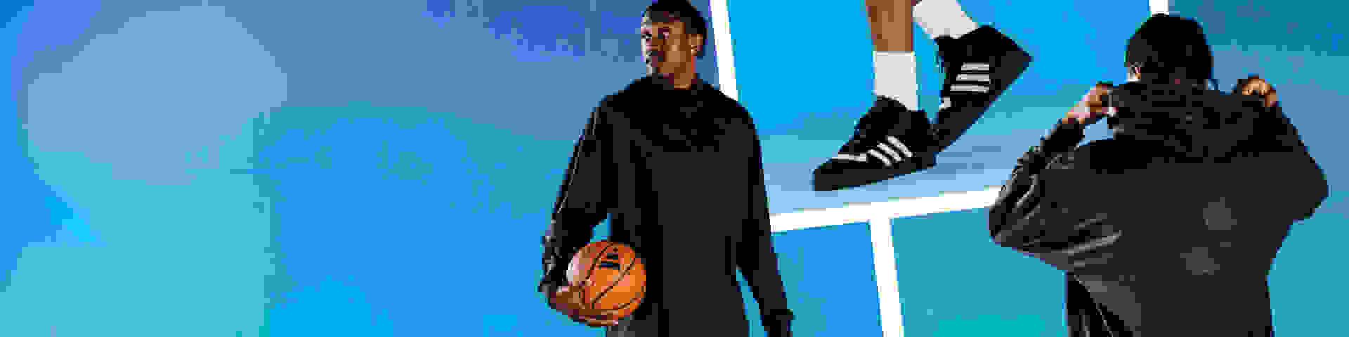 Collage of male basketball athlete wearing black top and shorts, white socks and three-stripes shoes, and holding basketball, against blue background