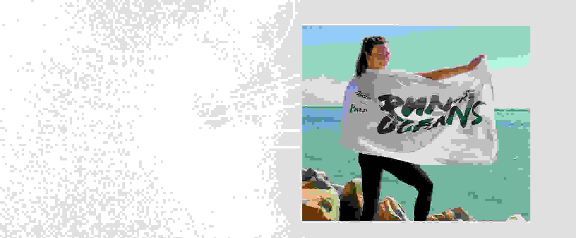 Karlie Kloss with Run for the Oceans flag by the ocean