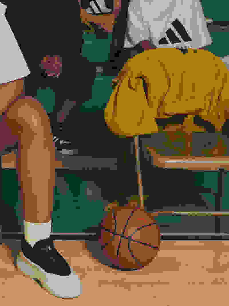 Courtside basketball scene with players sitting on benches
