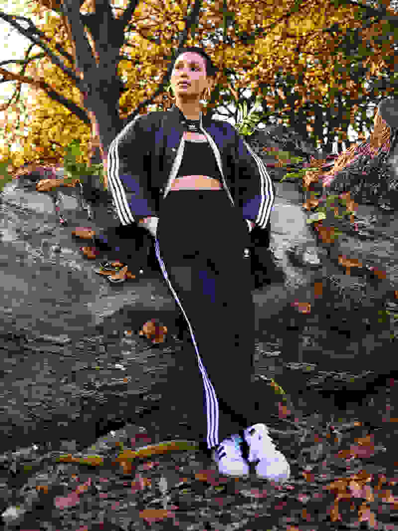 Woman standing amongst Fall leaves.