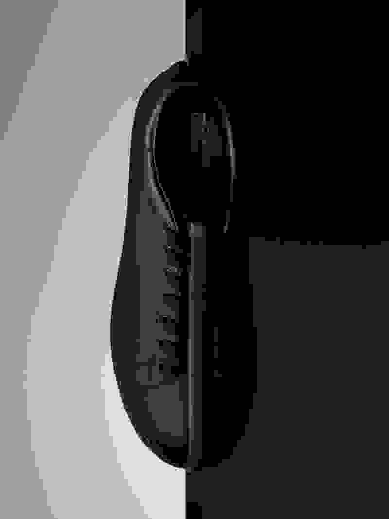 The CG Split Stan sneaker is pictured vertically in front of a half light, half dark backdrop.