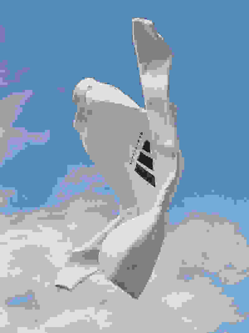 A white hooded sweatshirt with a large black adidas Basketball logo in front of a blue sky and white clouds.