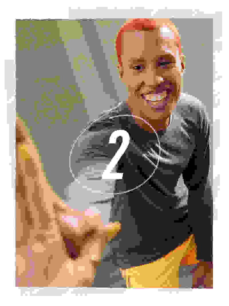 An image with a smiling boy in the background and the number 2 in the foreground