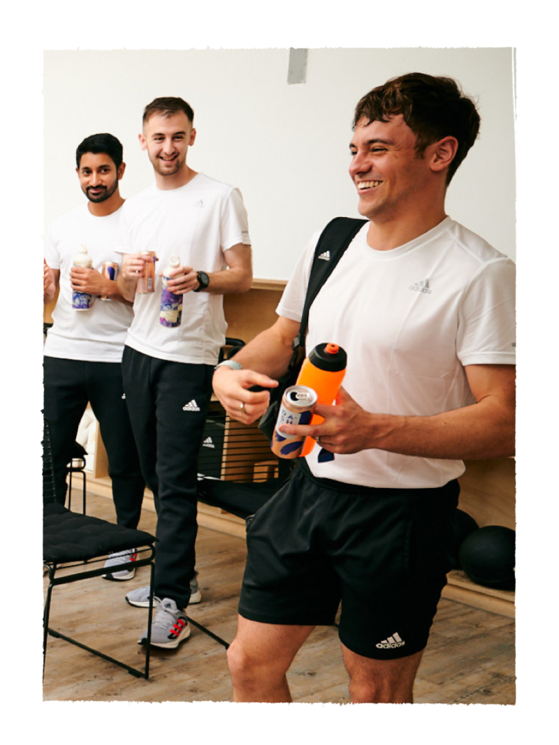 Image of three smiling men after a workout