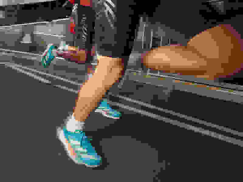 Close up of athletes legs wearing Adizero running shoes.