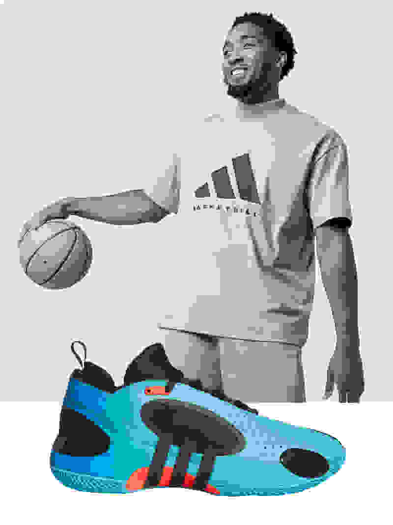 Black-and-white image of Donovan Mitchell smiling while bouncing basketball, with blue and black shoe superimposed in front of image