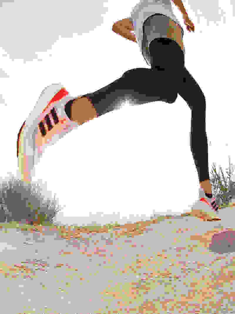 Image of person running outdoors wearing Ultraboost Light running shoes.