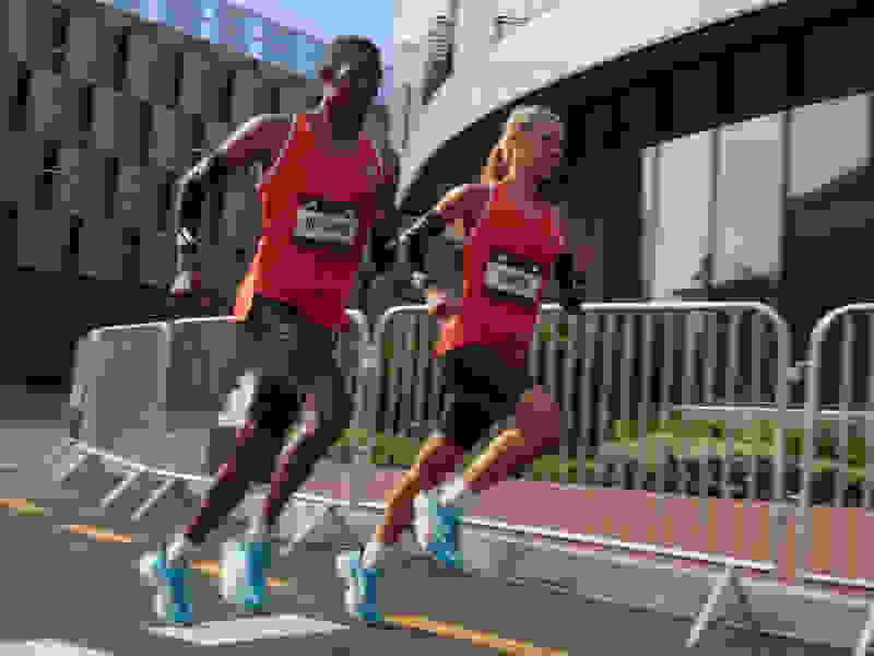 Race day close-up on male and female athletes running in Adizero apparel and footwear.