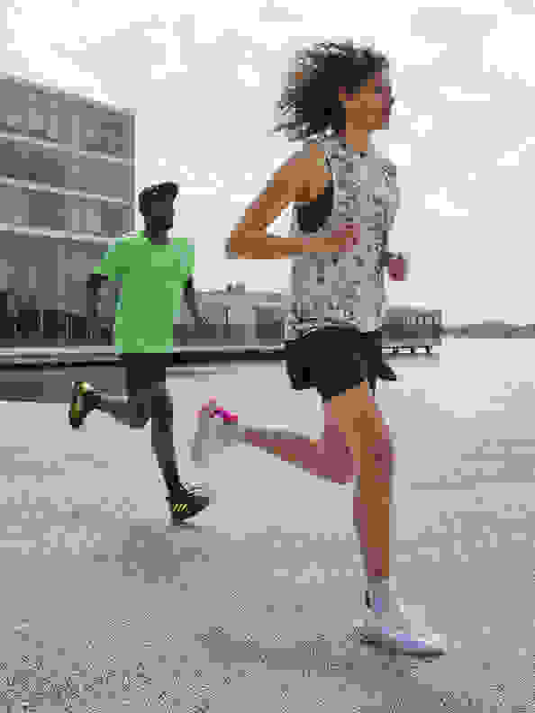 Side view of woman running with the new adidas 4DFWD running shoe.