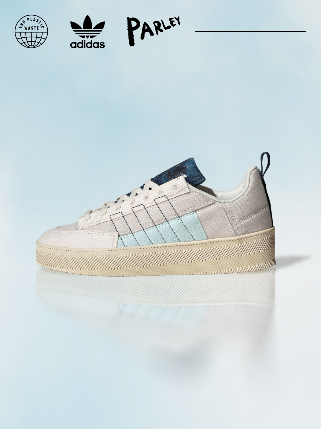 The Nizza sneaker in white with light blue 3-stripes and dark blue tongue is pictured from the side on a light blue background.
