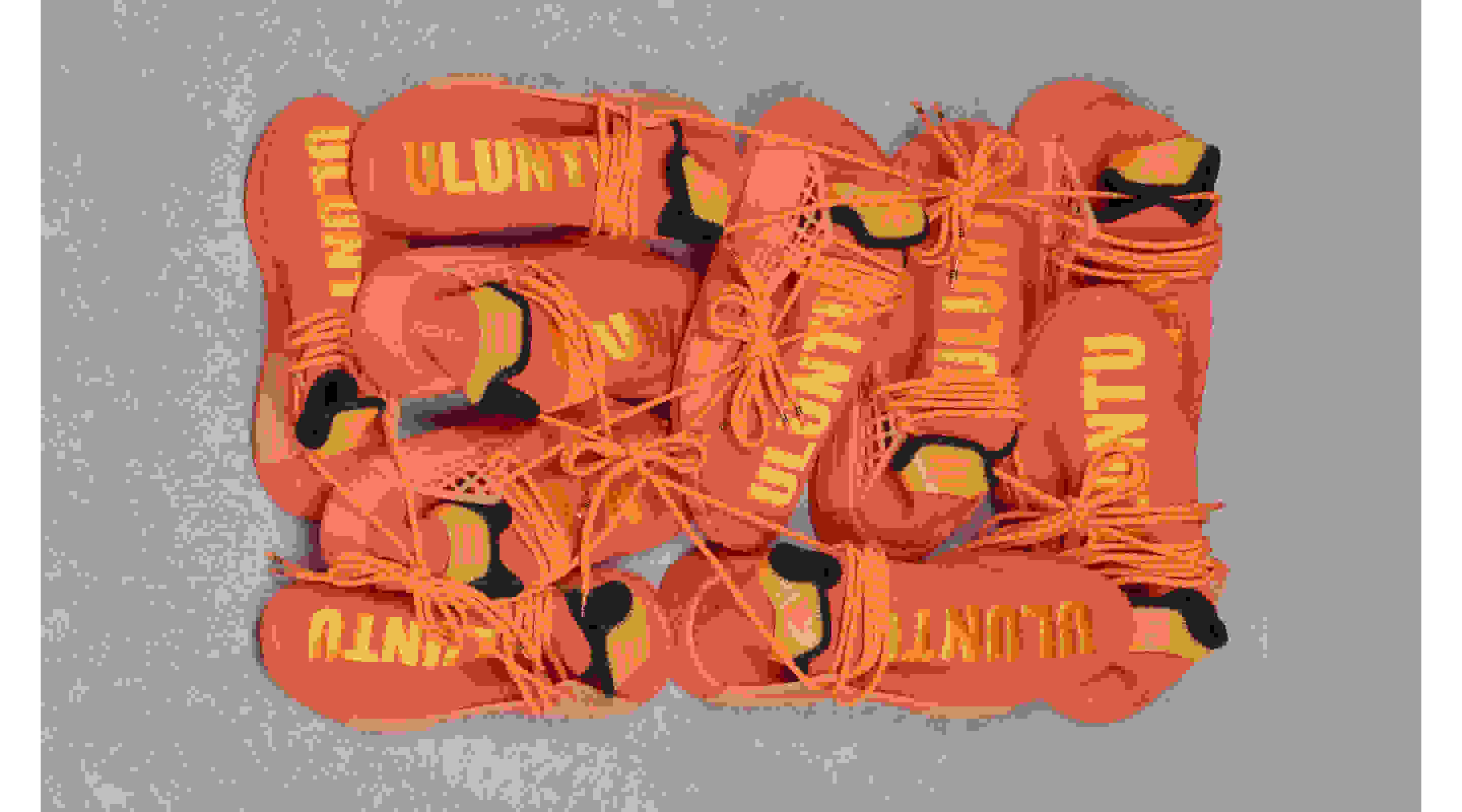 Close-ups of the HU NMD in the orange colourway with tonal Human Race graphics and lace-up.