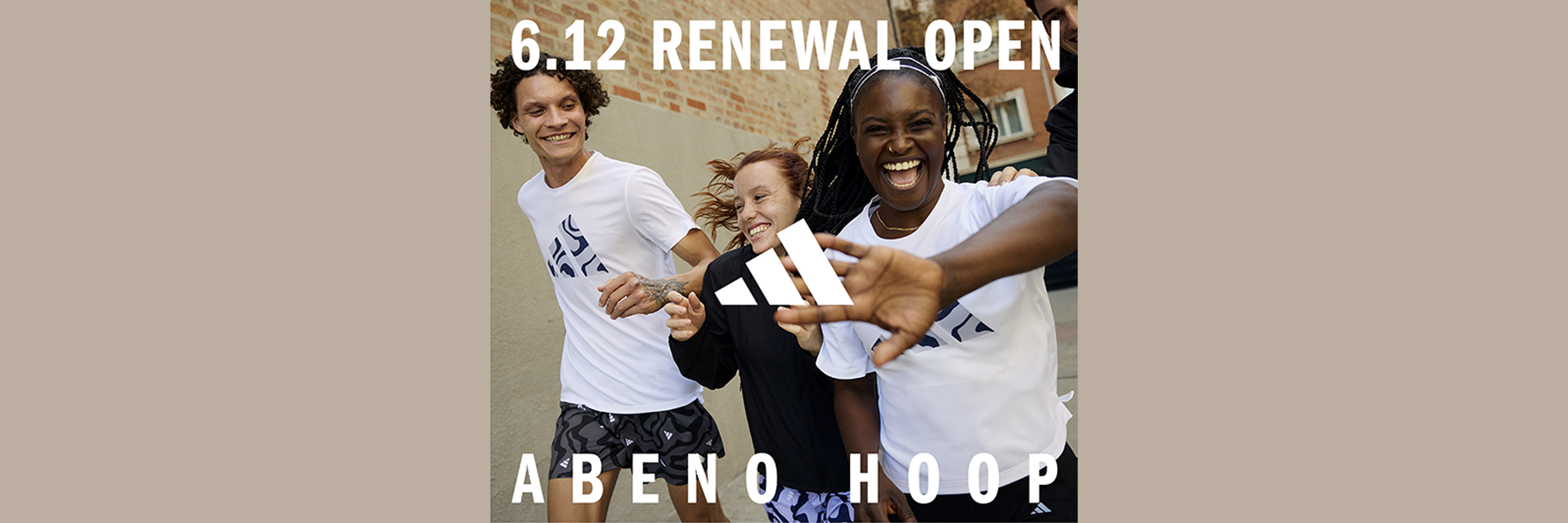 The image shows three individuals, two men and one woman, standing together and smiling. They appear to be in a public setting, with a sign in the background advertising a "6.12 Renewal Open" event for "Abeno Hoop".