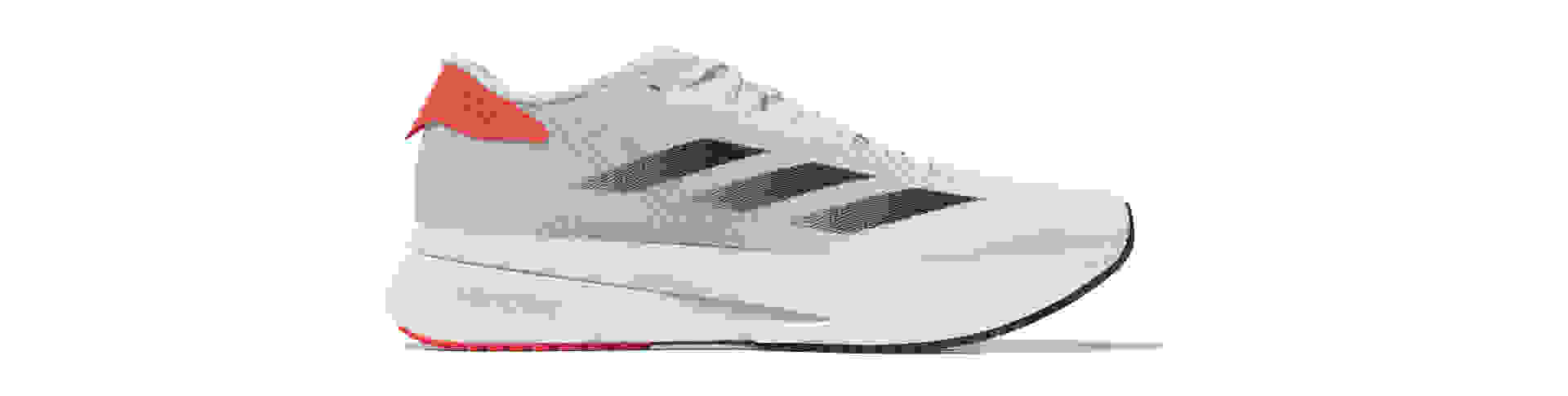 A white and red athletic shoe with a thick platform sole and a textured upper design.