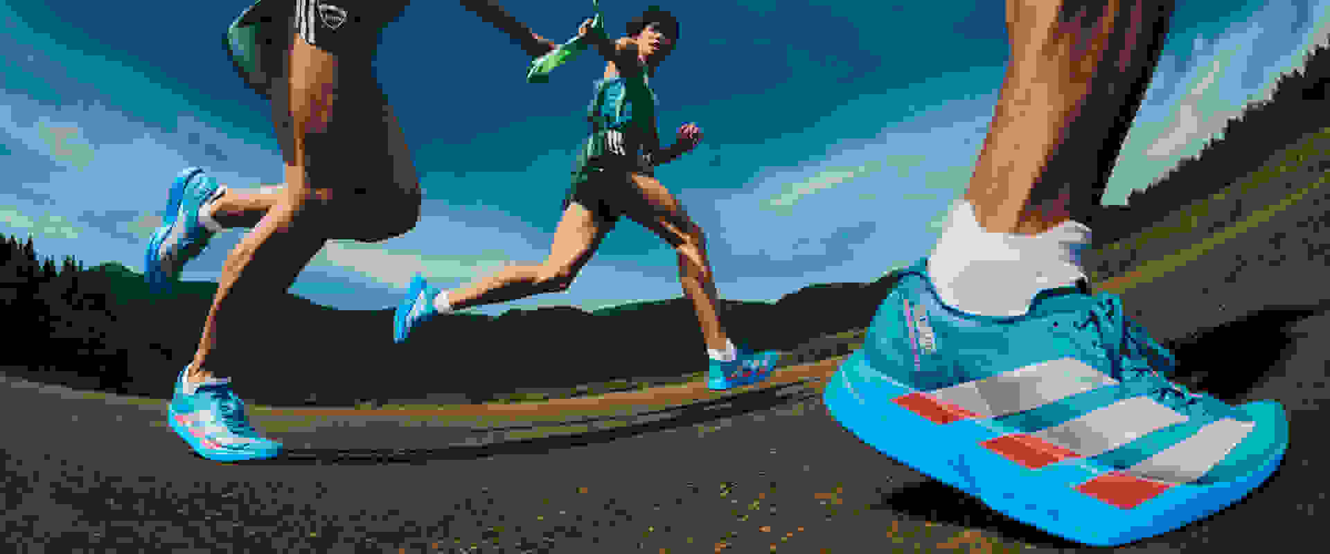 A person in athletic gear running on a dirt trail surrounded by mountains and a blue sky.