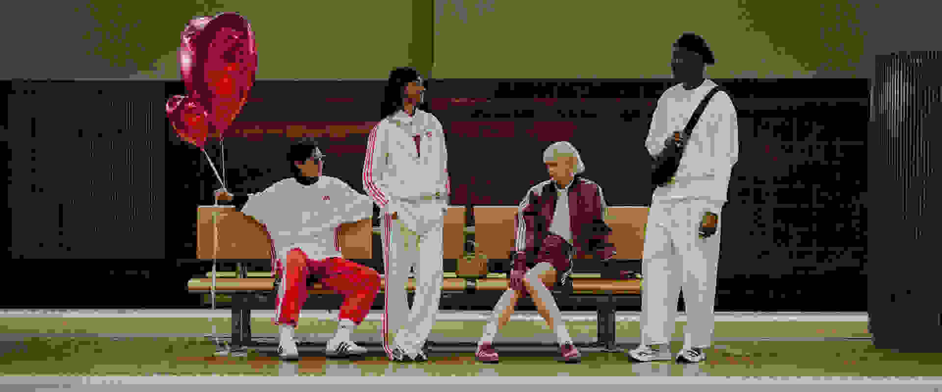 A group of individuals wearing stylish, coordinated outfits stand in a setting with a red heart-shaped balloon and a wooden bench in the background.