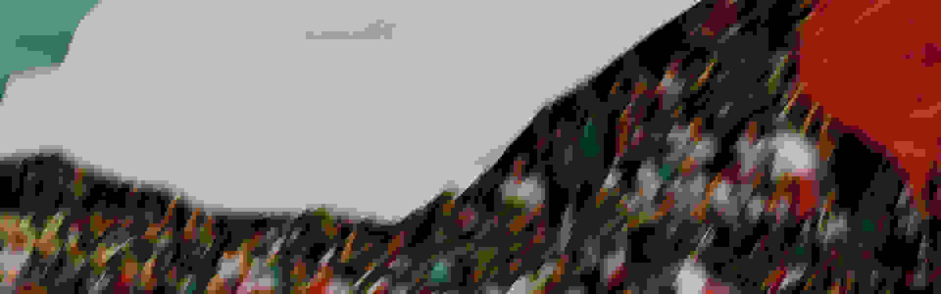 A blurred, abstract landscape with vibrant colors and shapes, creating a sense of movement and energy.