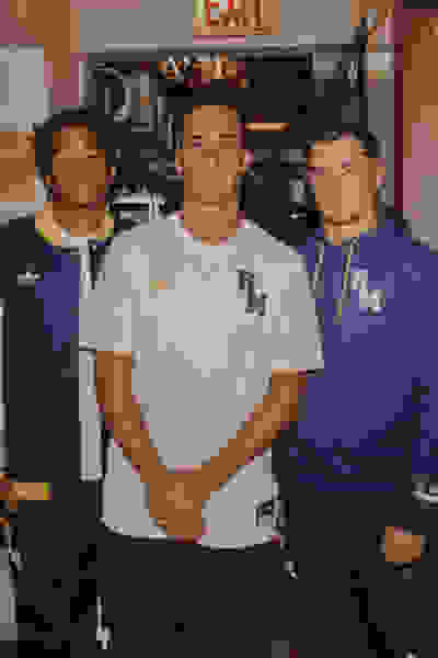 Three men wearing FC Real Madrid lifestyle gear