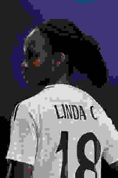 A female footballer wearing a Real Madrid Jersey