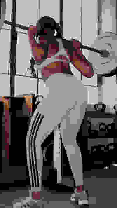 Image of model wearing the Optimé Collection in a gym environment. Hover over of another image with the same model doing a strength exercise.