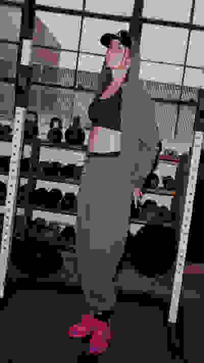 Image of model wearing the Optimé Collection in a gym environment. Hover over of another image with the same model doing a strength exercise.