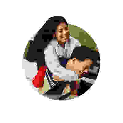 The image depicts a smiling woman embracing a man from behind in what appears to be a cozy, domestic setting.