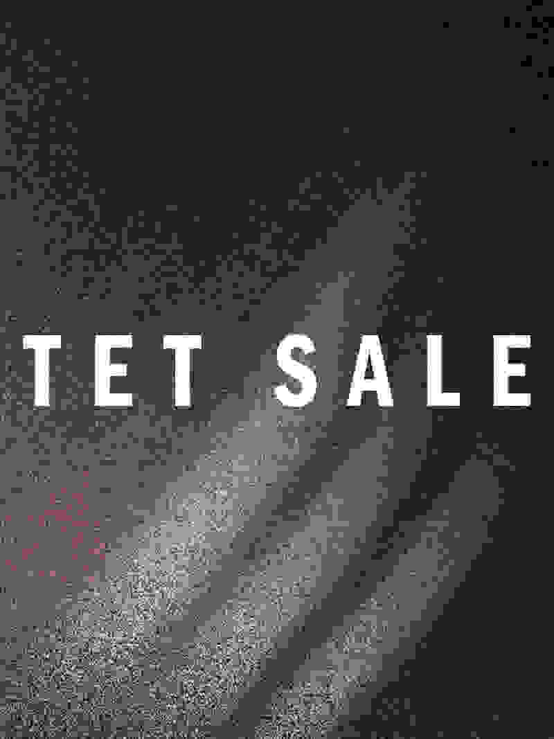 The image displays the text "TET SALE" against a dark, textured background with diagonal lines or rays of light emanating from the center.