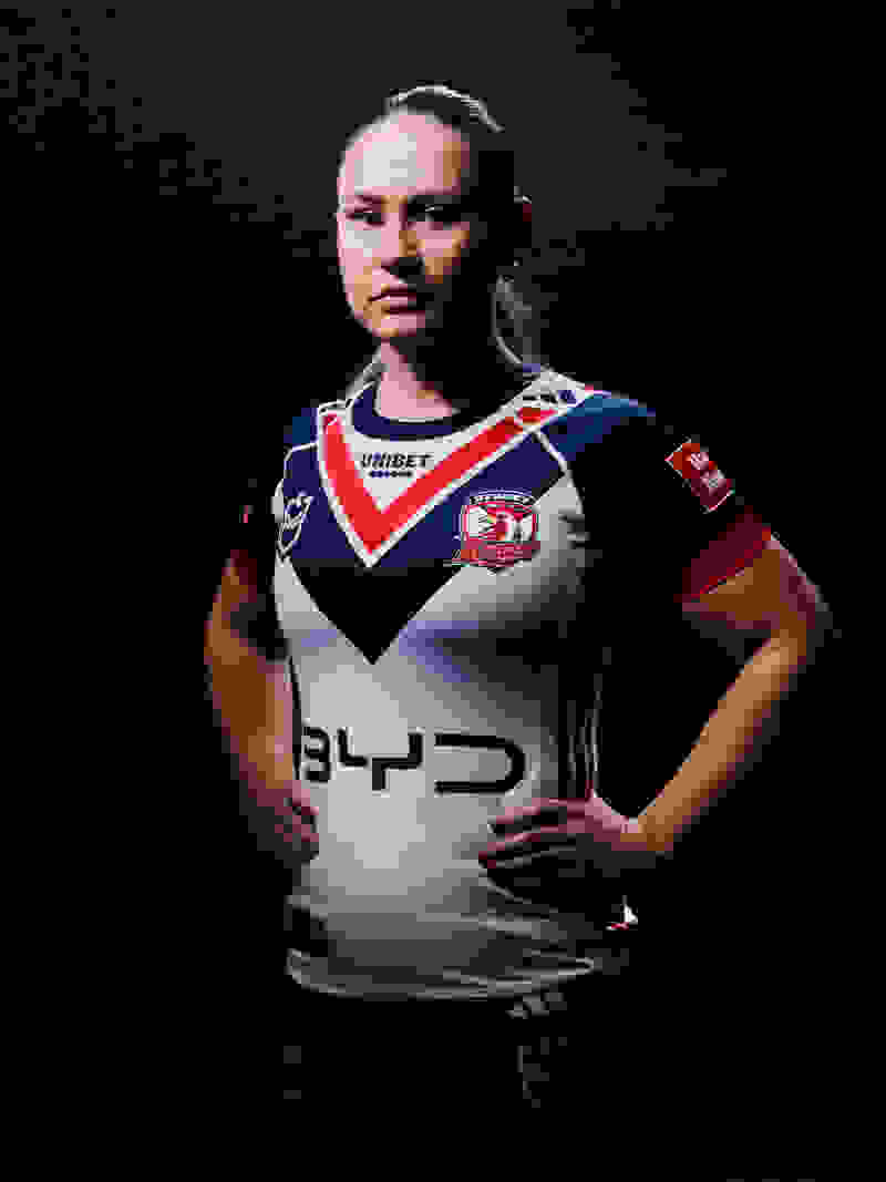 The image shows a person wearing a sports jersey with the number 3 and the team logo, standing in a dark background.