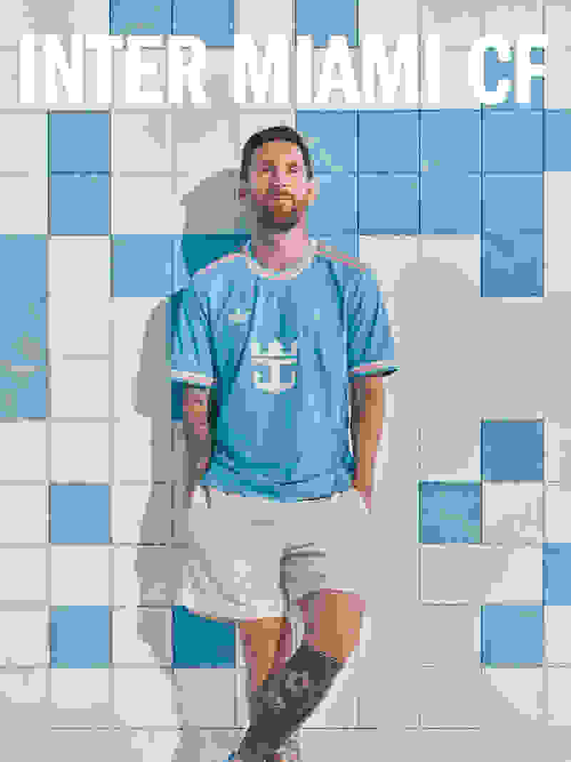 A man wearing a light blue soccer jersey with a logo stands in front of a tiled wall with the text "INTER MIAMI CF".